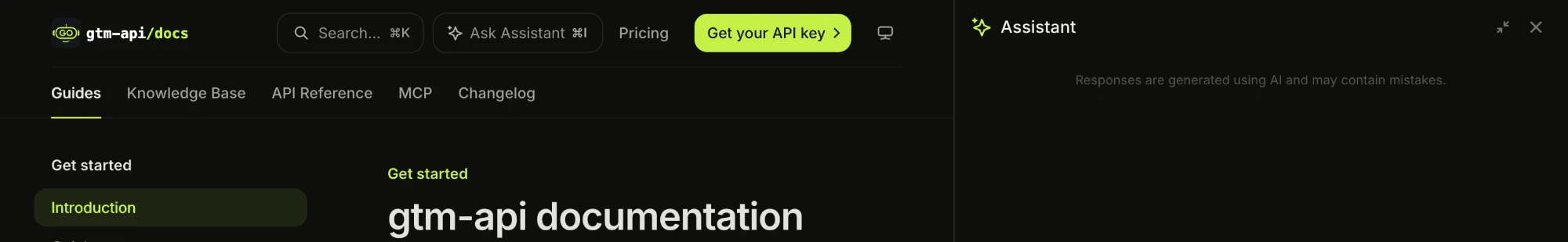The gtm-api.com docs with the Ask Assistant button in the top bar and the empty Assistant panel docked on the right